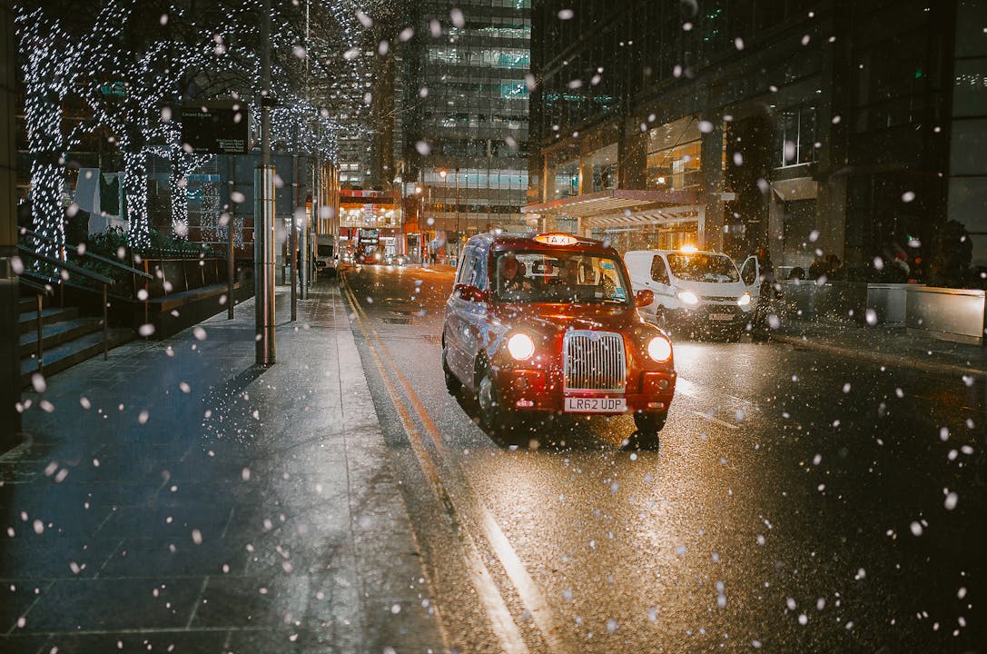 A red taxi driving at Christmas time
